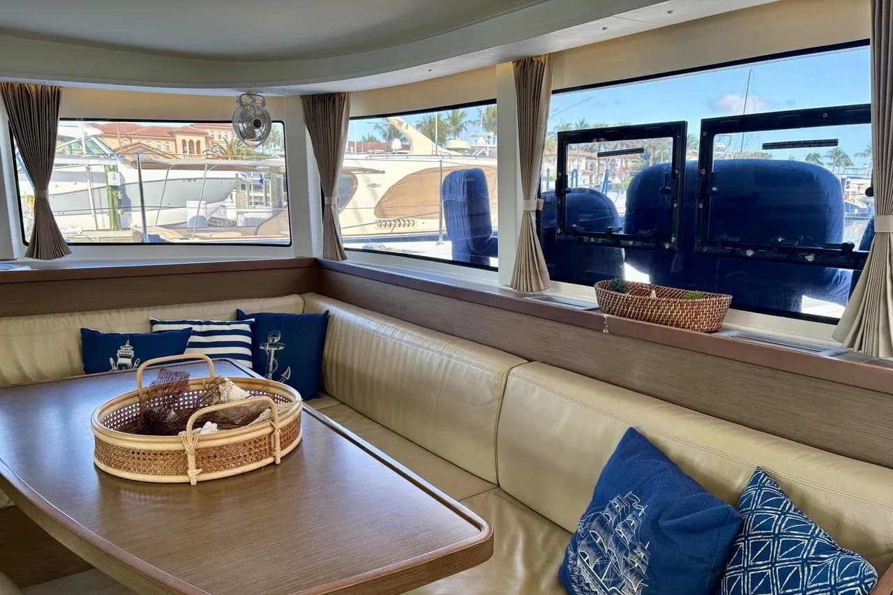 Aft deck lounge with panoramic views and open-air dining setup