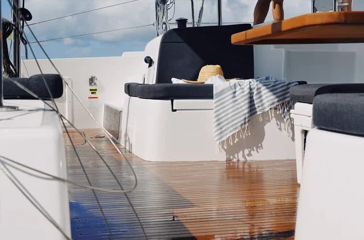 Guests relaxing on the bow net of Luna Cat with turquoise Treasure Coast waters ahead